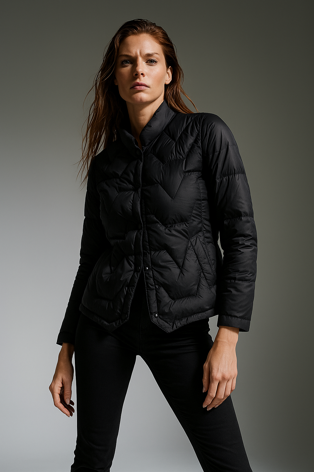 Black Aurora short quilted puffer jacket for women by Christine Brewer, showing the padded, stylish winter outerwear design.