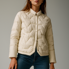 Ivory short quilted puffer jacket for women by Christine Brewer, featuring a warm, padded design and stylish fit.