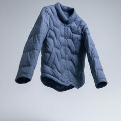 Floating blue quilted puffer jacket for women by Christine Brewer, featuring short, padded design and cozy insulation.