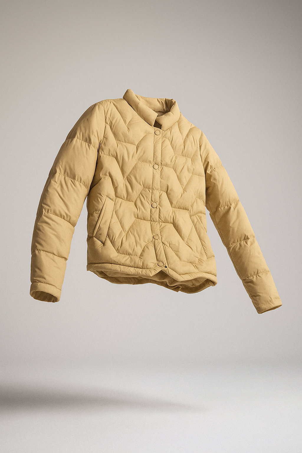 Women's Aurora short quilted puffer jacket by Christine Brewer, displayed on a floating jacket mannequin with a zipper and quilted pattern.