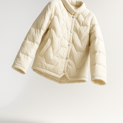 Women’s short quilted puffer jacket by Christine Brewer, stylish and warm, with a sleek design and quilted texture.