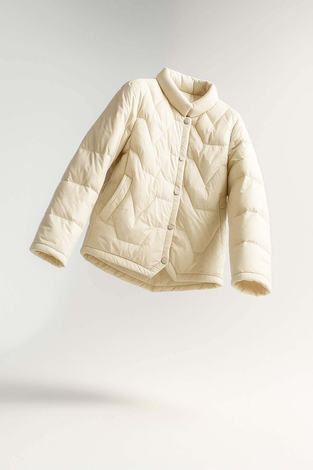 Women’s short quilted puffer jacket by Christine Brewer, stylish and warm, with a sleek design and quilted texture.