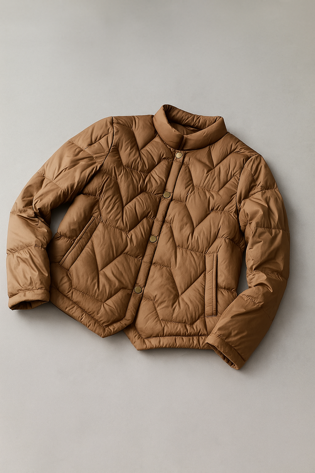 Women’s short quilted puffer jacket by Christine Brewer, stylish and warm for winter, shown in a sleek, quilted design.