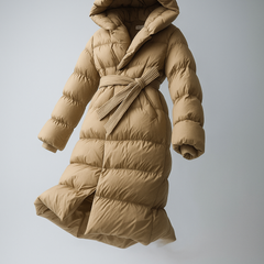 Long belted puffer jacket for women by Christine Brewer, featuring a stylish, insulated design with a belt and modern silhouette.