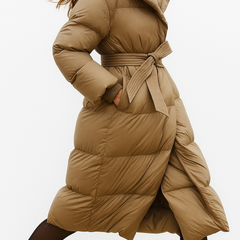 Stylish long belted puffer jacket for women by Christine Brewer, featuring a quilted design and cozy insulated fit.