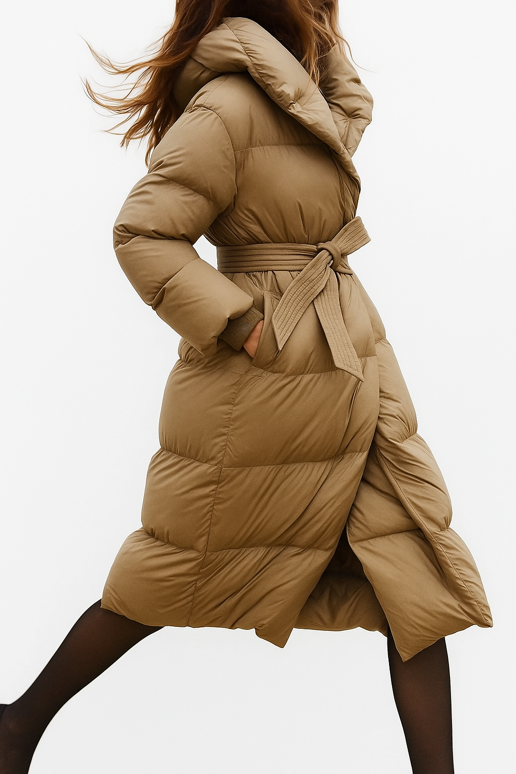 Stylish long belted puffer jacket for women by Christine Brewer, featuring a quilted design and cozy insulated fit.