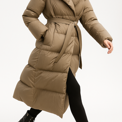 Ella long belted puffer jacket for women by Christine Brewer, featuring quilted design and a stylish belt for a chic winter look.