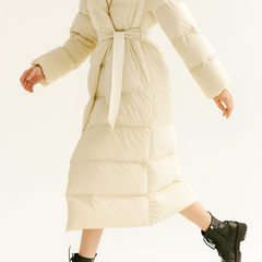 Ella long belted puffer jacket for women by Christine Brewer, stylish quilted outerwear with belt and hood for cold weather.