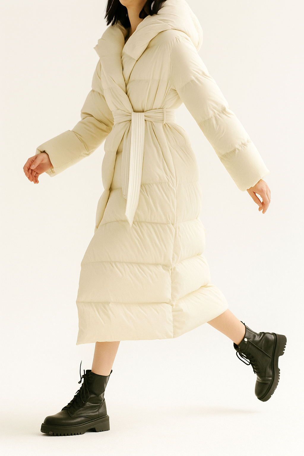 Ella long belted puffer jacket for women by Christine Brewer, stylish quilted outerwear with belt and hood for cold weather.