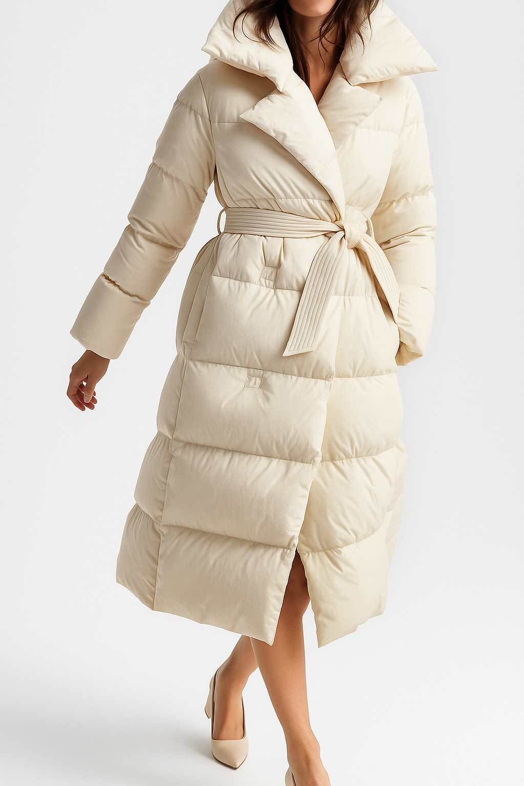 Elegant long belted puffer jacket for women by Christine Brewer, featuring a stylish quilted design and cozy insulation.