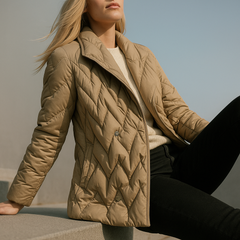Beige Chloe belted quilted puffer jacket for women, featuring a stylish design with a waist belt and puffy quilted texture.