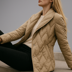 Beige Chloe belted quilted puffer jacket for women by Christine Brewer, featuring a stylish quilted design and adjustable belt.