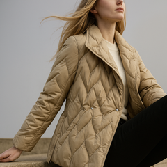 Beige Chloe belted quilted puffer jacket for women, stylish and warm with a quilted design and waist belt, by Christine Brewer.