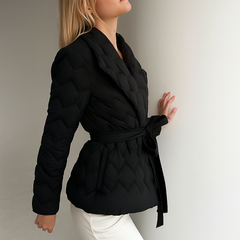 Black Chloe belted quilted puffer jacket for women by Christine Brewer, displayed on a mannequin, showcasing its stylish winter design.