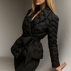 Black Chloe belted quilted puffer jacket for women by Christine Brewer, displayed on a mannequin with front view.