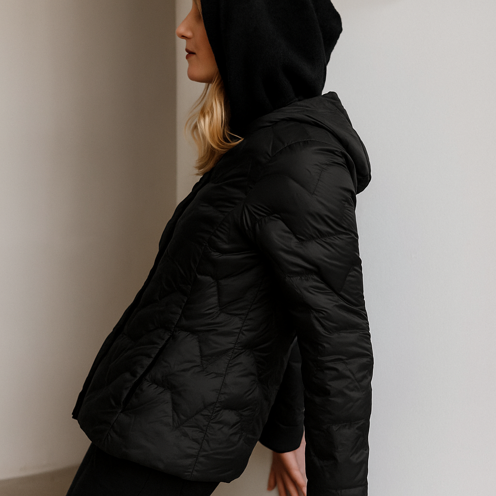 Black Zoe hooded quilted puffer jacket for women by Christine Brewer, featuring a cozy hood and quilted design.