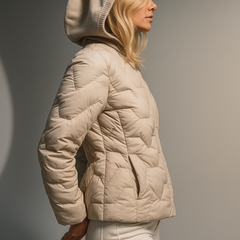 Christine Brewer Zoe women's hooded quilted puffer jacket in cozy beige, featuring a warm, insulated design and quilted texture.