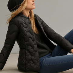 Black Zoe hooded quilted puffer jacket for women by Christine Brewer, displayed on a mannequin with a front view.