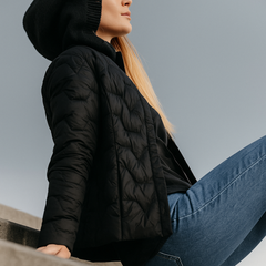 Black Zoe hooded quilted puffer jacket for women by Christine Brewer, displayed on a mannequin with a front view.