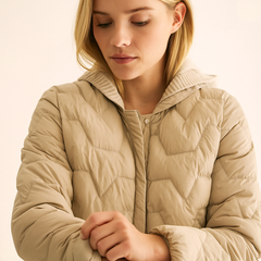 Women's quilted puffer jacket with hood by Christine Brewer, featuring a warm, padded design and front zipper closure.