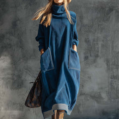 Blue corduroy midi dress by Christine Brewer, casual dress with a fitted bodice and flowing skirt, shown on a model.