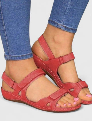 Open-toe ankle-strap sandals for women by Christine Brewer showing stylish straps and a block heel on a white background.