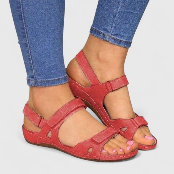 Open-toe ankle-strap sandals for women by Christine Brewer showing stylish straps and a block heel on a white background.
