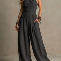 Charcoal pinstripe halter neck wide-leg jumpsuit for women by Christine Brewer, featuring a stylish halter top and flowing wide-leg pants.