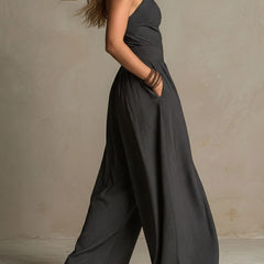 Women's charcoal pinstripe halter neck wide-leg jumpsuit from Christine Brewer, shown on a model with a relaxed fit and stylish design.