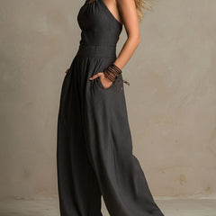 Charcoal pinstripe halter neck wide-leg jumpsuit for women by Christine Brewer, featuring a stylish halter top and flowy wide-leg pants.