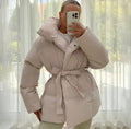 Christine Brewer Alice belted puffer jacket for women, featuring a cozy, quilted design with a waist belt and stand-up collar.