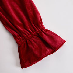 Red velvet pleated ruffled long sleeve blouse by Christine Brewer, featuring a stylish, textured design and elegant ruffle details.