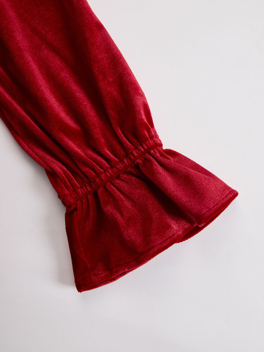 Red velvet pleated ruffled long sleeve blouse by Christine Brewer, featuring a stylish, textured design and elegant ruffle details.