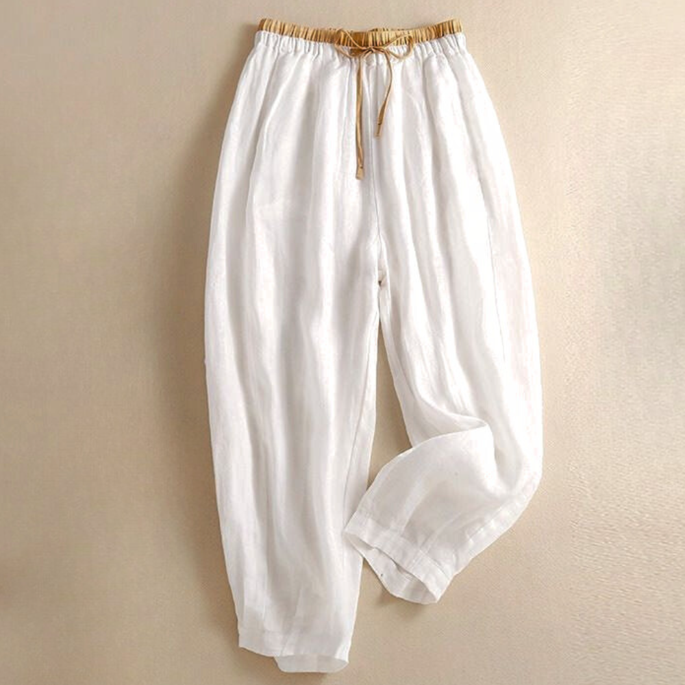 Relaxed fit tapered linen trousers for women by Christine Brewer, featuring a loose pull-on design and lightweight fabric.