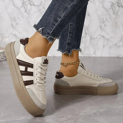 Elegant women's striped flowy sneakers by Christine Brewer, featuring stylish design and comfortable fit.