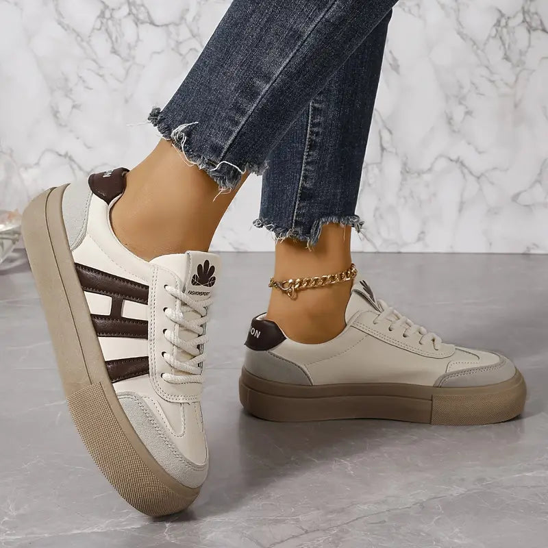 Elegant women's striped flowy sneakers by Christine Brewer, featuring stylish design and comfortable fit.