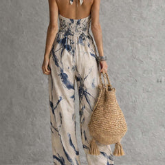 White ink wash print halter neck wide-leg jumpsuit with pockets for women by Christine Brewer, featuring a stylish, relaxed fit.