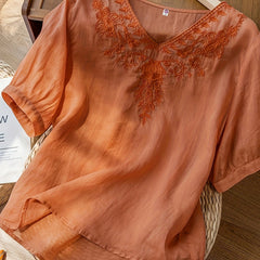 Light beige summer blouse for women by Christine Brewer featuring a V-neck and flowy linen fabric, casual and breathable top.