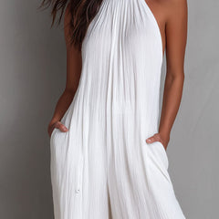 White pleated halter neck wide-leg resort jumpsuit for women by Christine Brewer, featuring stylish design and comfortable fit.