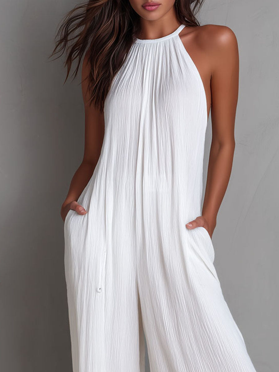 White pleated halter neck wide-leg resort jumpsuit for women by Christine Brewer, featuring stylish design and comfortable fit.