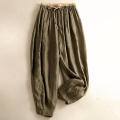 Light beige tapered linen trousers for women by Christine Brewer, loose pull-on style with a relaxed fit and comfortable waist.
