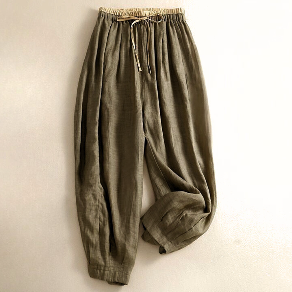 Light beige tapered linen trousers for women by Christine Brewer, loose pull-on style with a relaxed fit and comfortable waist.