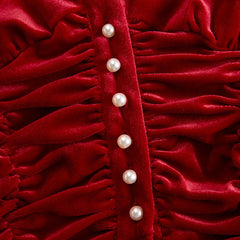 Red velvet pleated ruffled long sleeve blouse by Christine Brewer, featuring elegant ruffles and pleats on a rich red fabric.