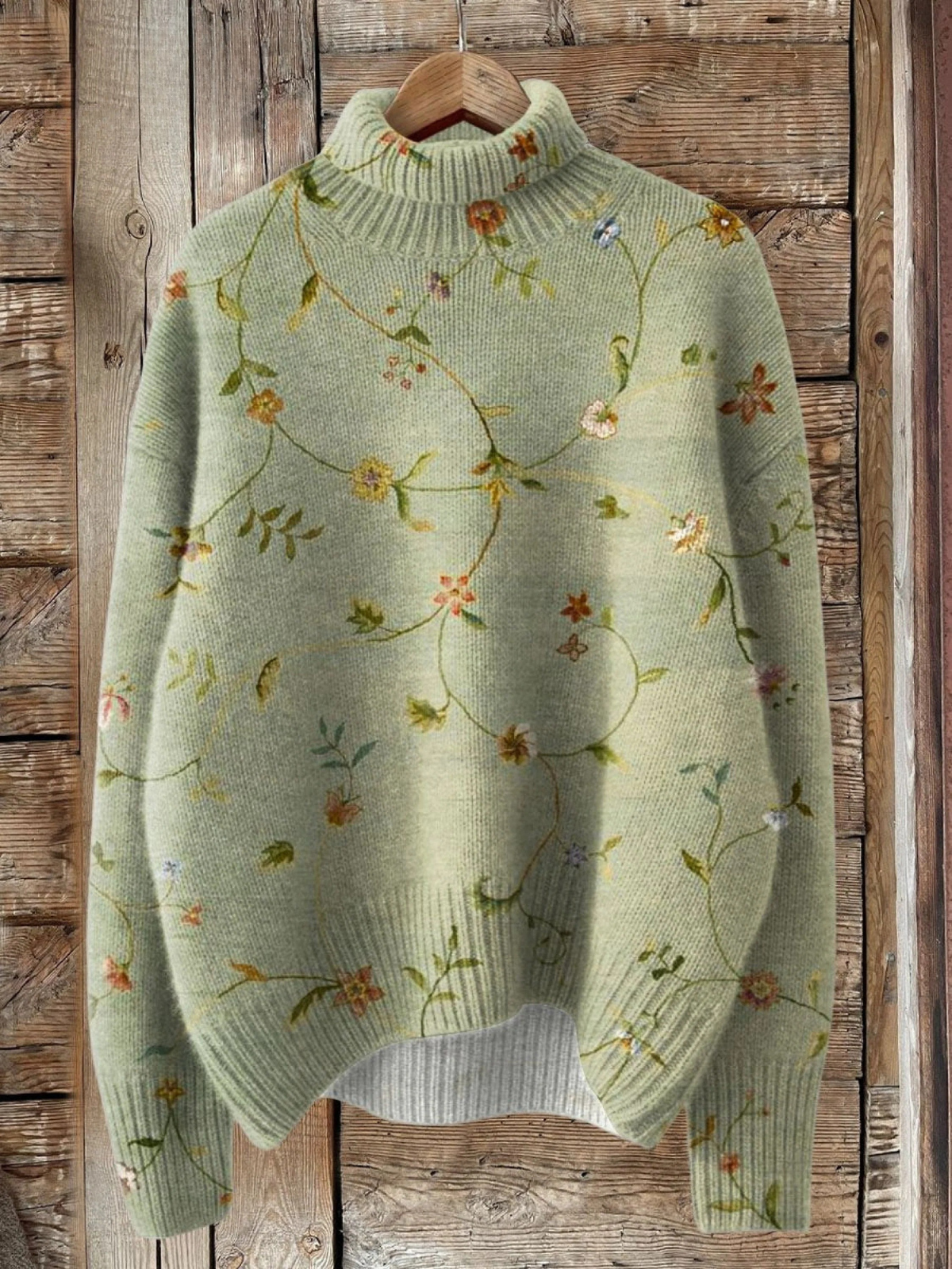 Women’s floral graphic sweater by Christine Brewer featuring colorful flower patterns on a cozy knit fabric.
