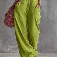 Bright green cotton linen zip-front jumpsuit for women, stylish and comfortable, by Christine Brewer, shown on a hanger.