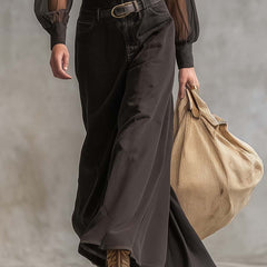 Black denim V-neck maxi dress by Christine Brewer, casual style, flowing length, sleeveless design, and fitted waist.