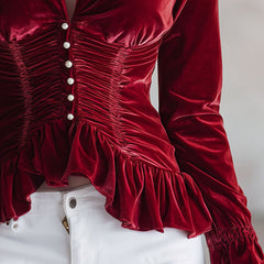 Red velvet pleated ruffled long sleeve blouse by Christine Brewer, featuring elegant design and detailed ruffle accents.