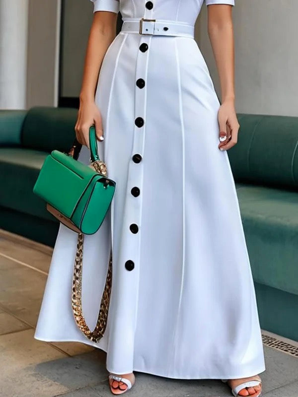 White maxi dress with puff sleeves, belted waist, and button details by Christine Brewer, featuring a lapel collar and solid color design.