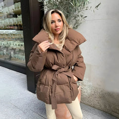 Women’s Alice belted puffer jacket from Véron the Label, featuring a quilted design and adjustable belt for a stylish winter look.