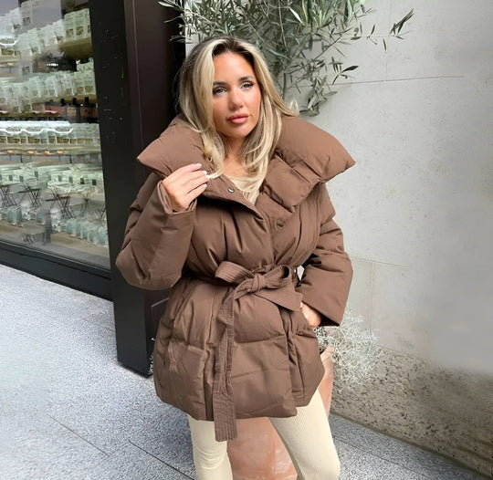 Women’s Alice belted puffer jacket from Véron the Label, featuring a quilted design and adjustable belt for a stylish winter look.